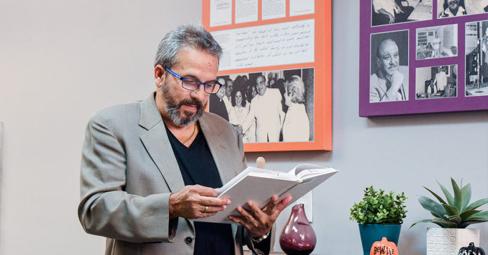 Albizu University professor reading a psychology book